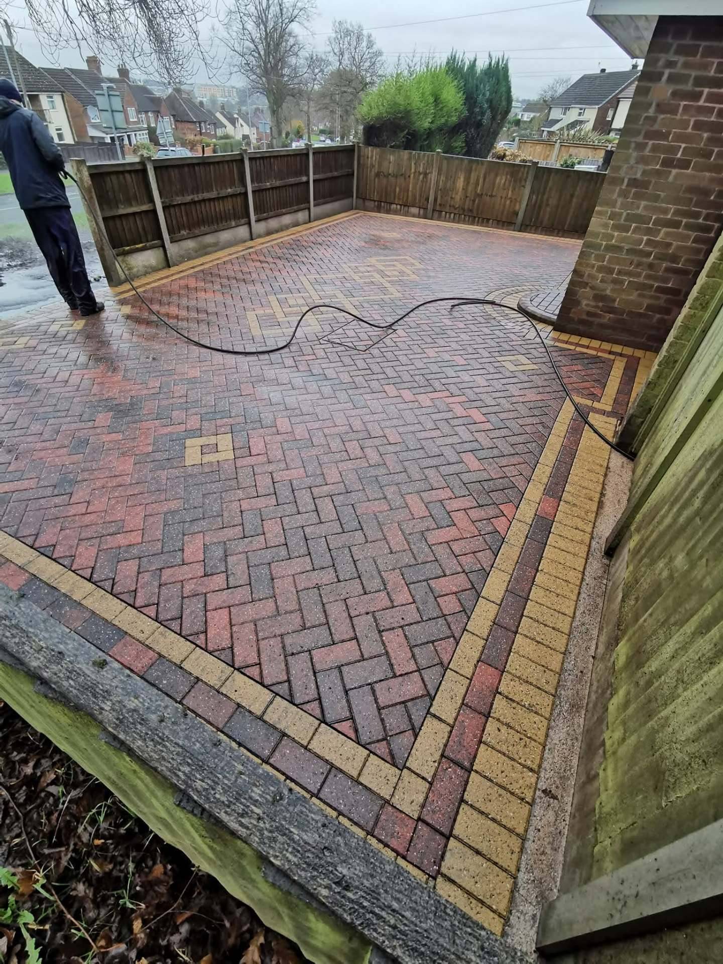 Block paved driveway — moss, weeds and leaves washed away — after cleaning