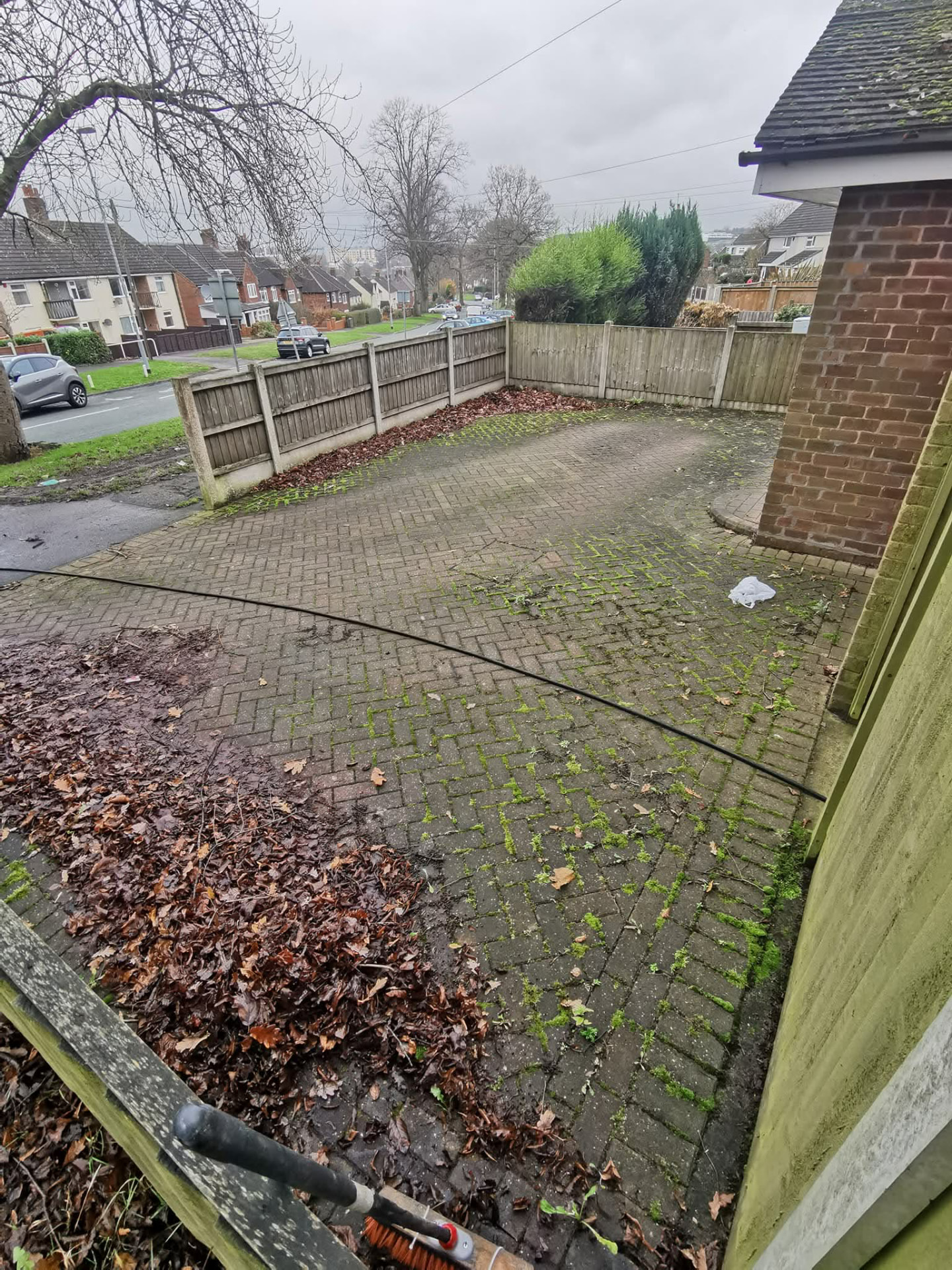 Block paved driveway — moss, weeds and leaves washed away — before cleaning