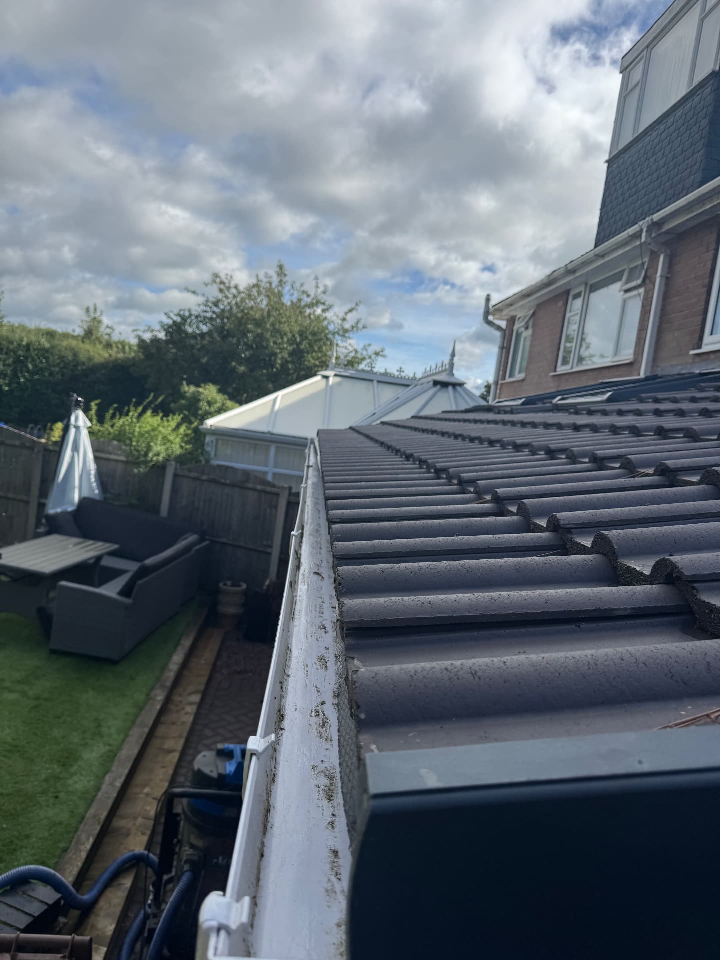 Gutter cleared out — leaves and moss removed — after cleaning