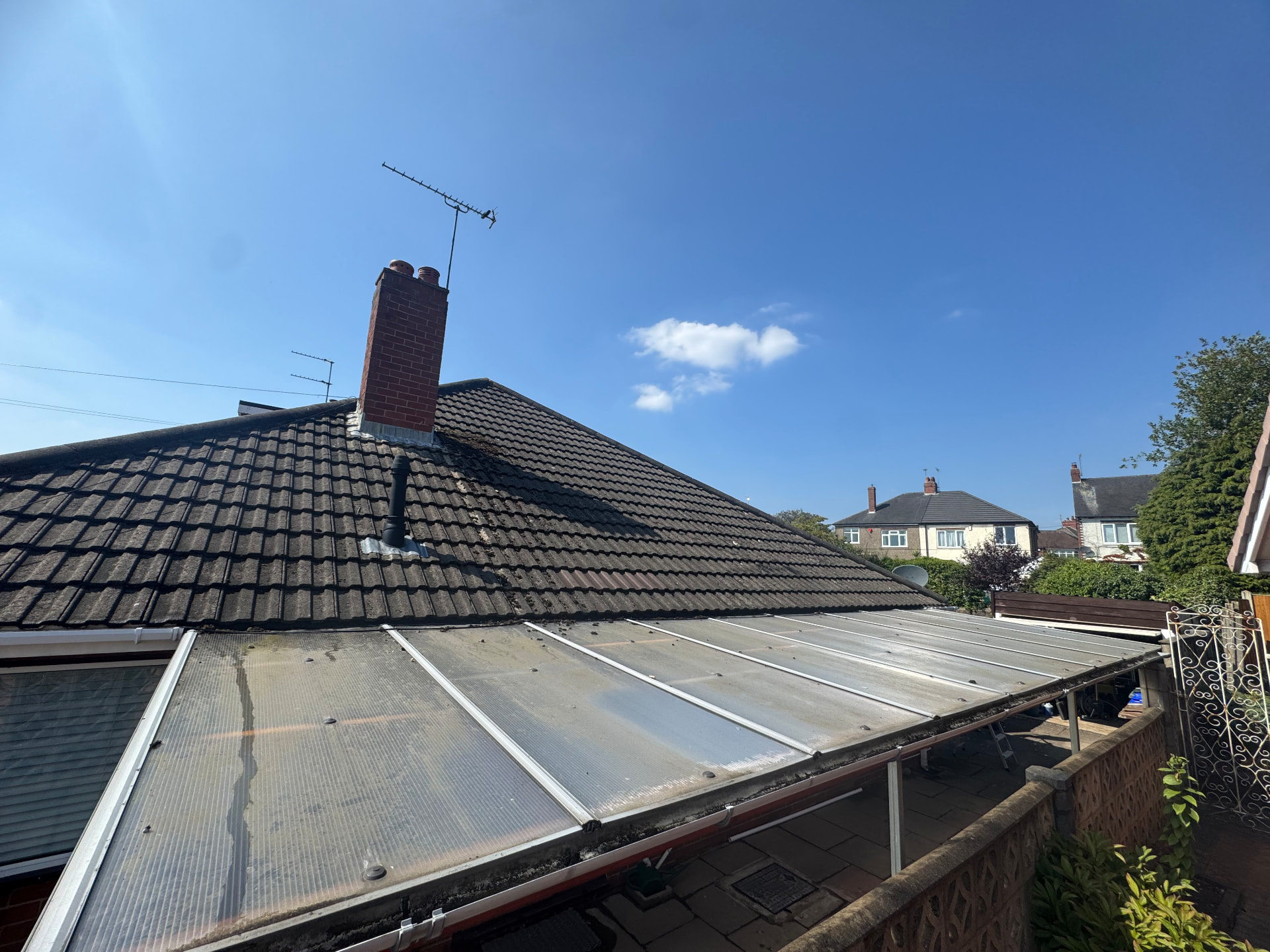 Patio awning roof — algae and grime stripped back to clear — before cleaning